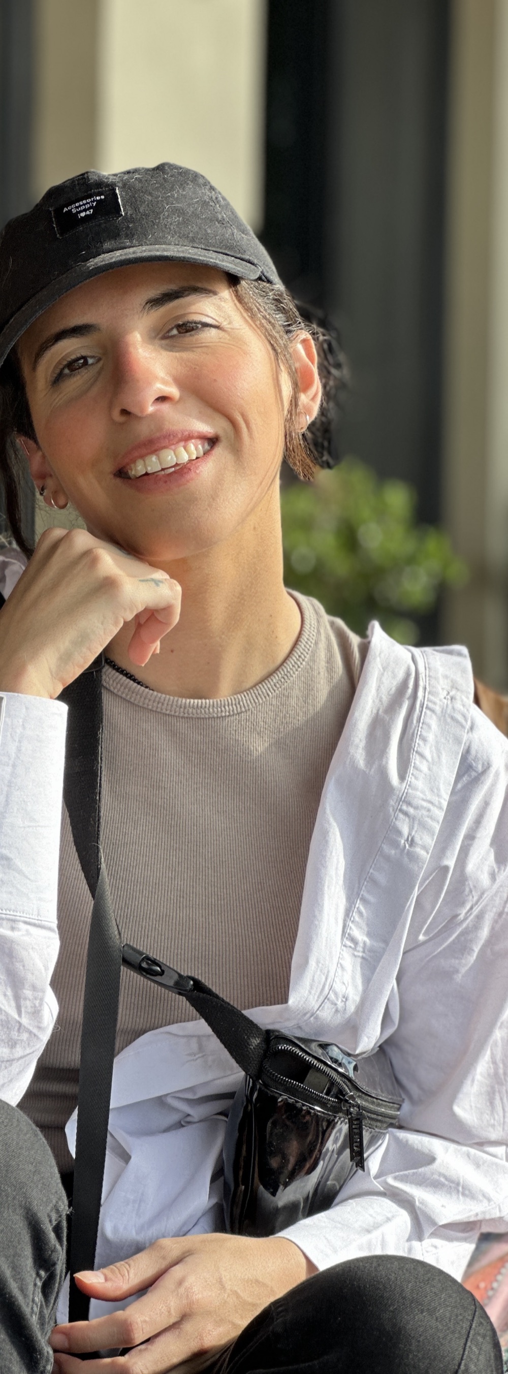 Catalina Villamil, smiling, wearing a cap and a white shirt